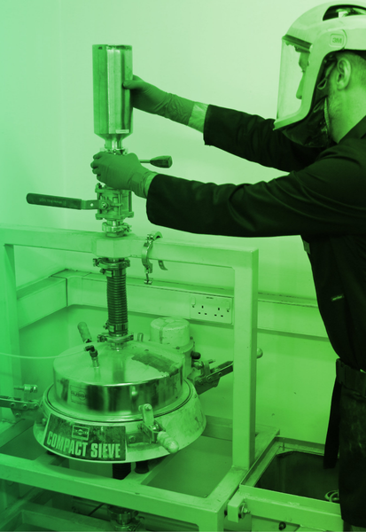 Atomik team member James operating the sieve.